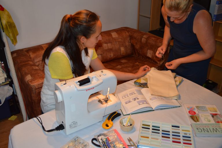 The sewing tutor teaching her student